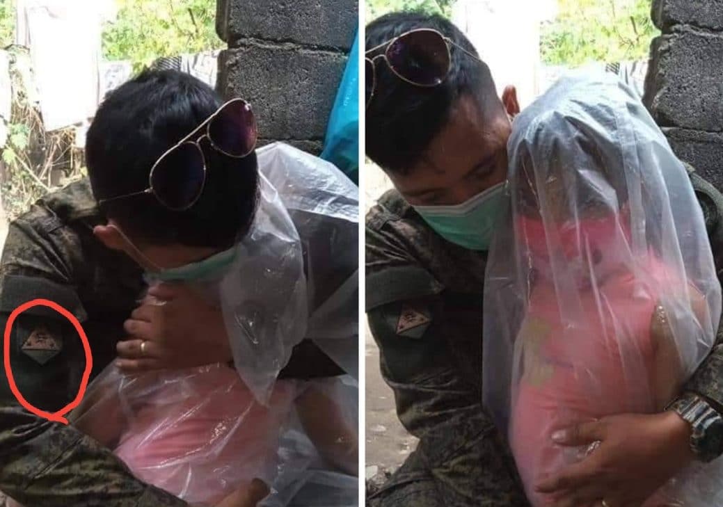 صورة لجندي فلبيني يغلف طفلة بغطاء ليعانقها دون التعرض للاصابة بكورونا